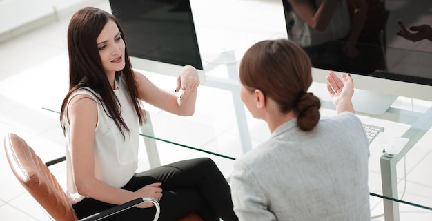 Employees of the company discuss work issues at the desktopoffice weekdays