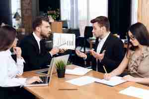 Photo employees of company hold a meeting at the table.