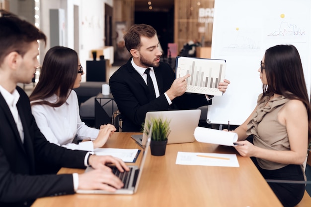 Employees of company hold a meeting at the table.