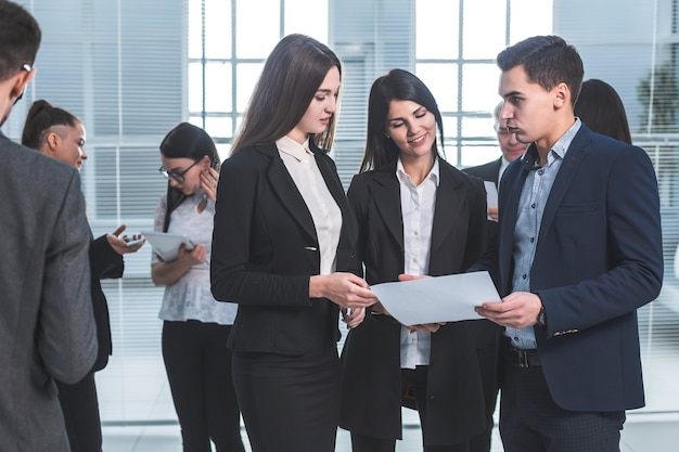 employees discuss a business document