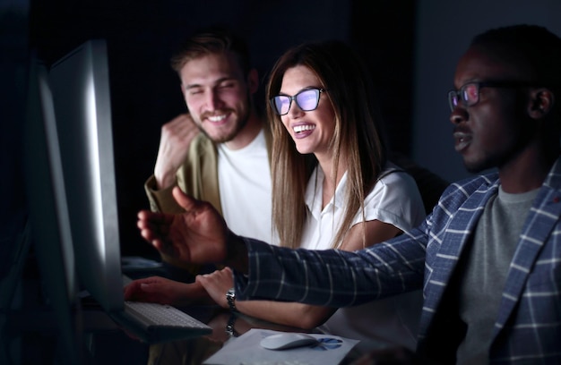 Employees discussing something sitting at the Desk