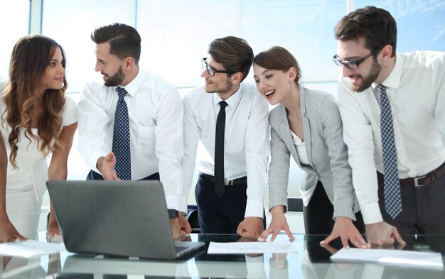 Employees look closely at the laptop screenpeople and technology