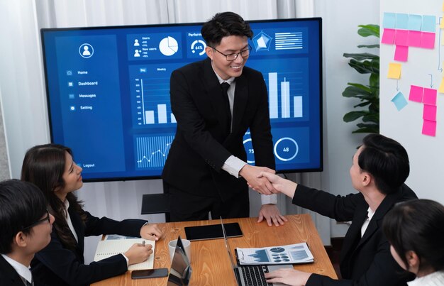 Photo employees shake hand for symbol of harmony after successful business meeting