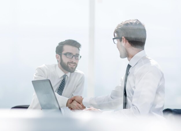 Employees shaking hands at the Desk