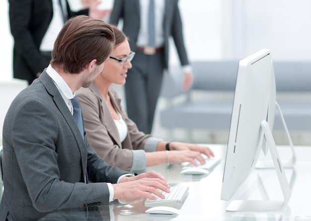 Employees sitting at a Desk in the Bank office