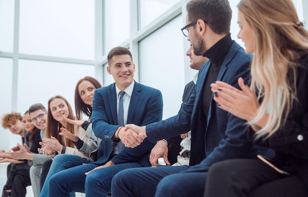 Employees supporting each other with a handshake