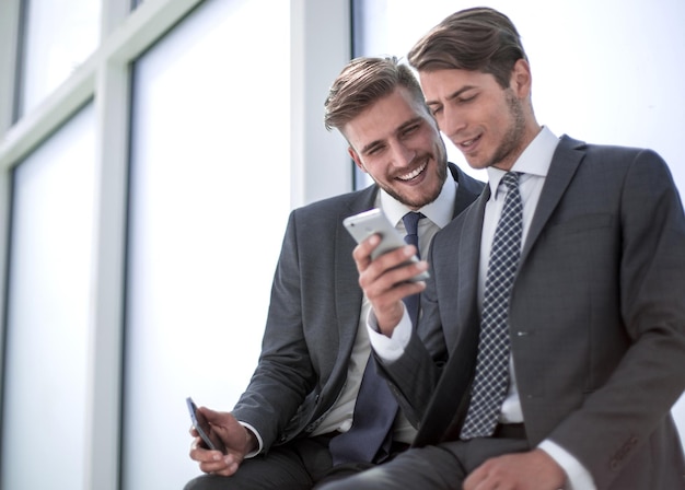 Employees watch videos on a smartphone