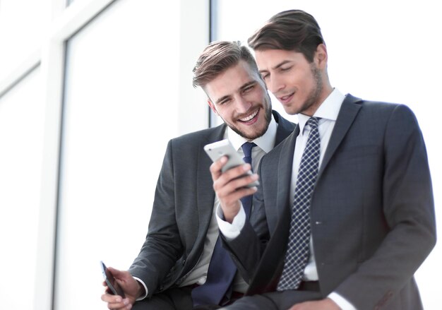 Employees watch videos on a smartphone