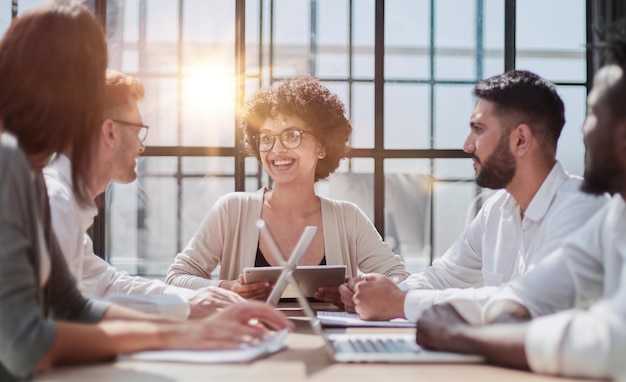 Employees working at computer together discussing content