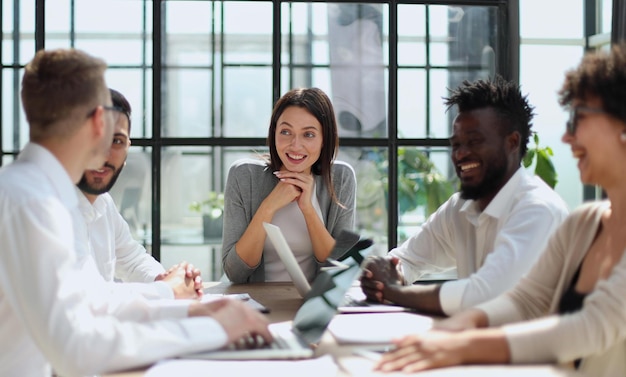 Employees working at computer together discussing content