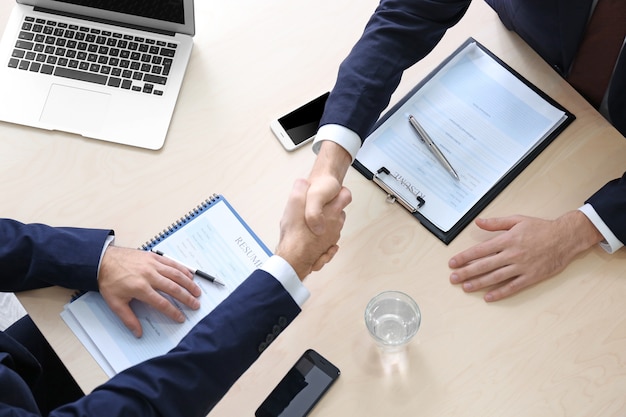 Employer and applicant shaking hands after interview