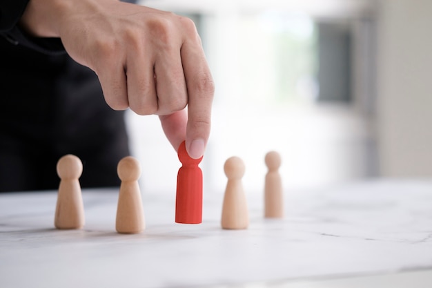 employer chooses takes in hand employee. leader stands out from crowd. looking for good worker. hr, hrm, hrd concepts