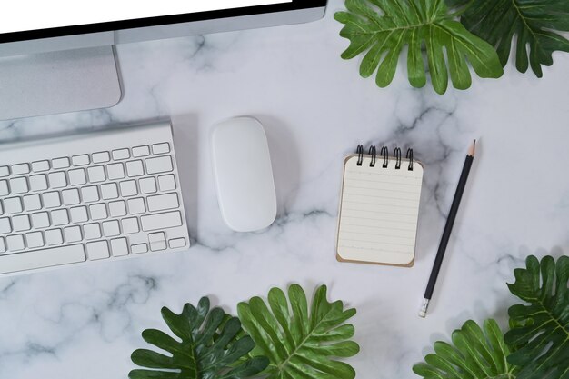 Empt notebook and computer on marble background.