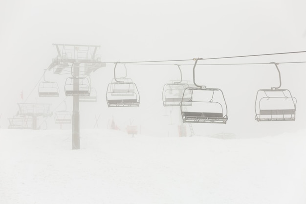 Empty abandoned chairlift during the snowstorm.