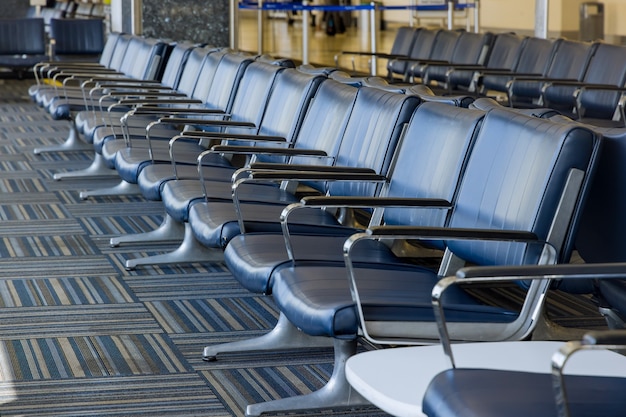 Empty airport departure lounge terminal waiting area with chairs