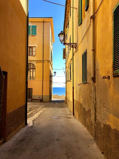 Empty alley amidst buildings in city