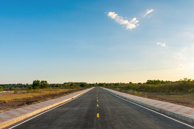 Empty asphalt road and clean blue sky in summer day background with copy space