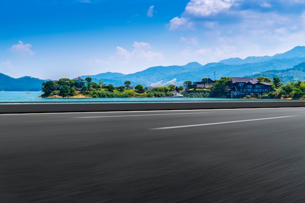 Empty asphalt road and natural landscape under the blue sky