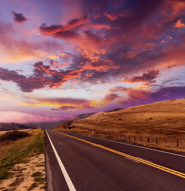 Empty asphalt road at sunset