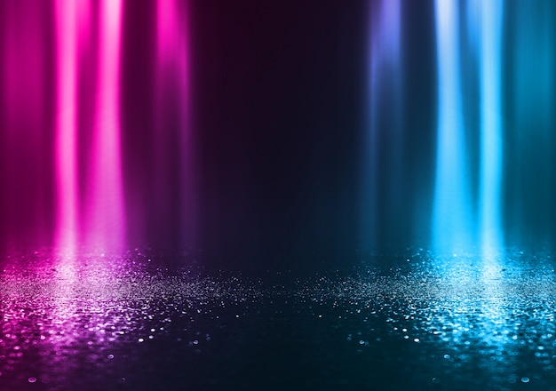 Empty background scene. dark street reflection on wet asphalt.
rays of neon light in the dark, neon shapes, smoke. background of
an empty stage show. abstract dark background.