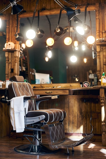 Empty barber chair in wooden interior Vintage workplace in studio for haircuts Barbershop background theme Side view