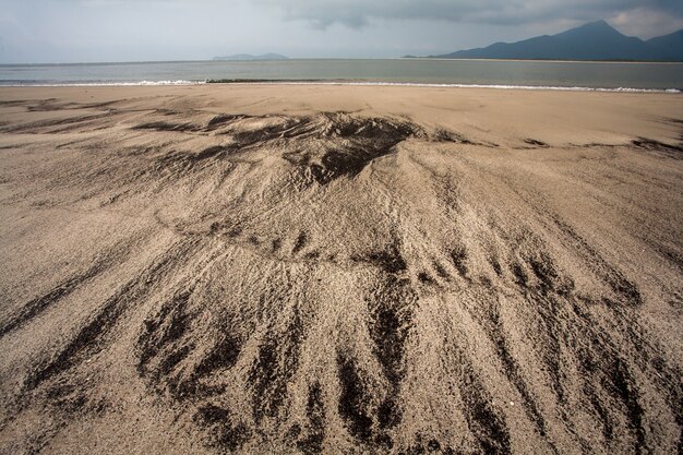 Spiaggia vuota con diverso modello sulla sabbia