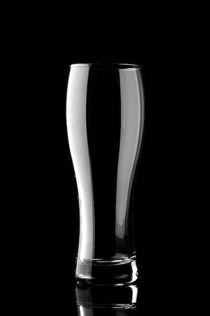 Empty beer glass isolated on black background