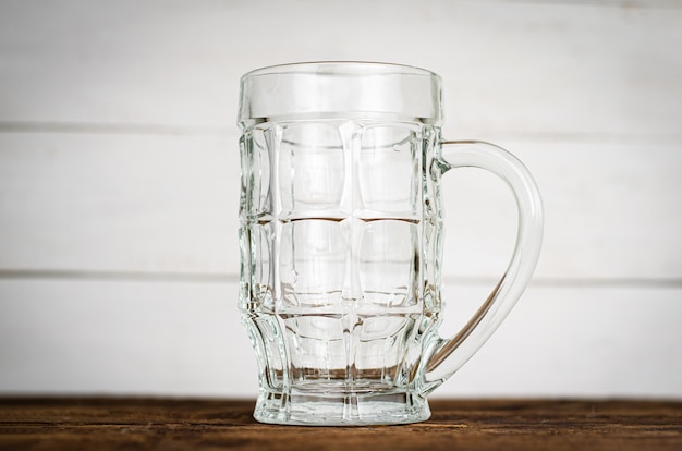 Empty beer pint, mug on wooden table.