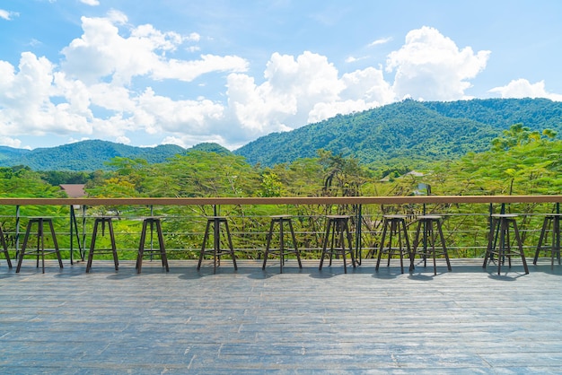 empty bench and bar stool on balcony with mountain hill backgrpund