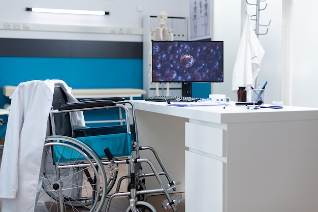 Empty bight medical office with nobody in it having coronavirus cell image on computer screen during covid19 global pandemic. Hospital room equipped with modern furniture. Virus illustration