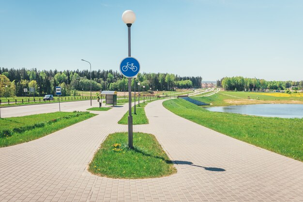 Empty bike and walking path near road.