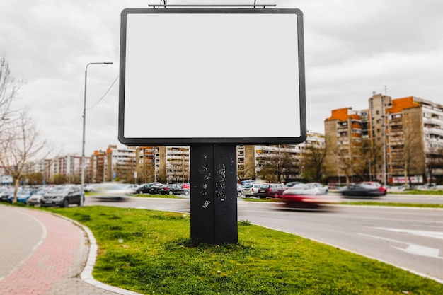 An empty billboard in the middle of city road