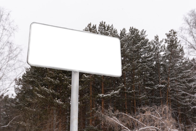 an empty billboard near the forest. winter and snow. for advertising