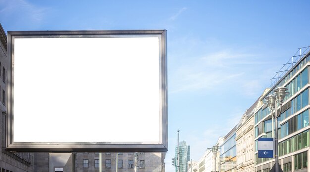 Empty billboard for public advertisement on the roadside Space for text Blue sky and city background