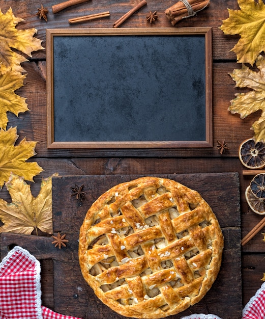 Empty black chalk board and baked whole fruit cake 