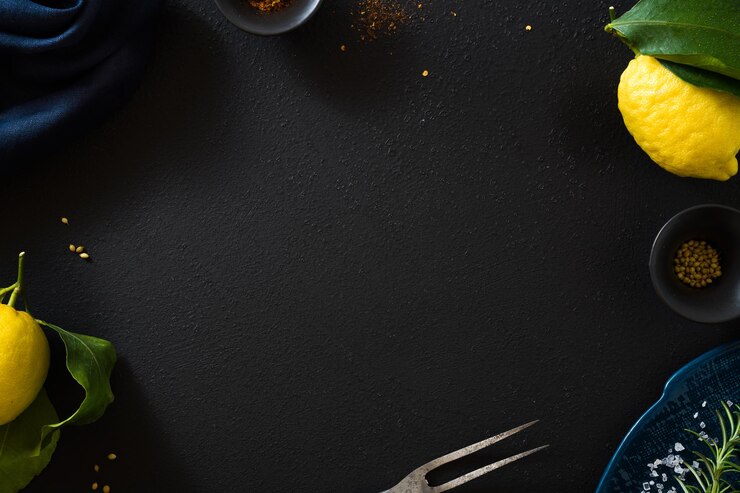 Empty black food background with lemons for writing text or advertising