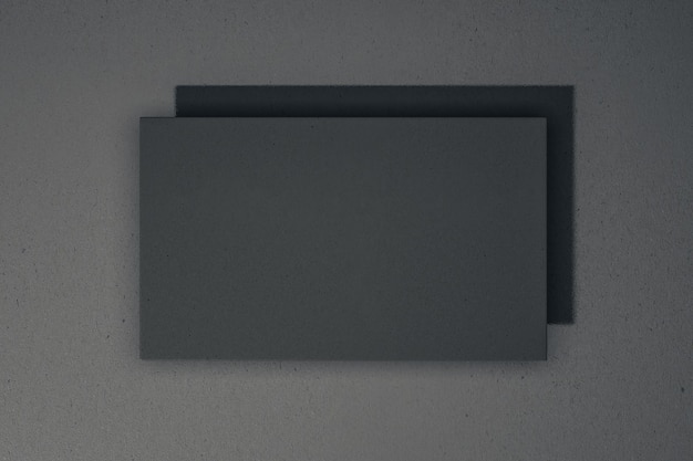 Empty black poster hanging on concrete wall