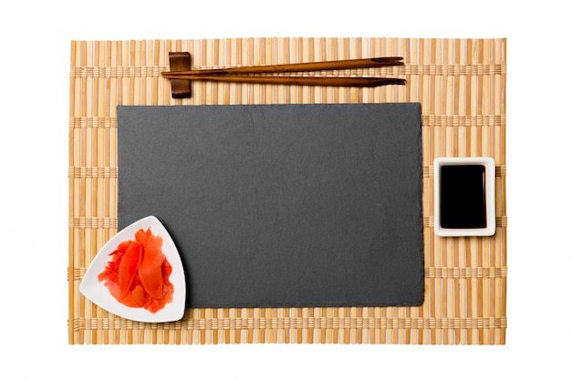 Empty black slate plate with chopsticks for sushi