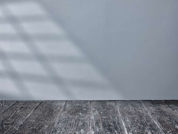 Empty black table top with light from window on background