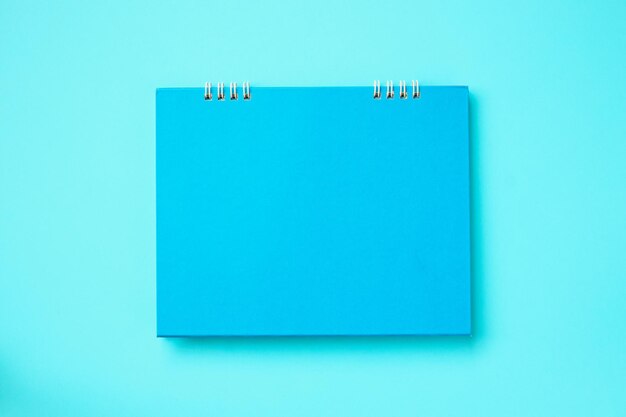 Empty blank calendar on blue background