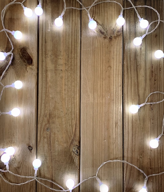 Photo empty blank photo frame in christmas decorated background christmas toys and fir branches on wood