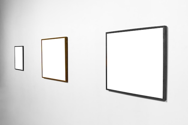 Empty blank picture wooden frame in interior on white wall