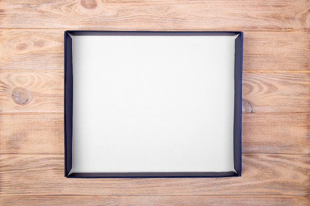 A empty blank white box on the desk table. top view