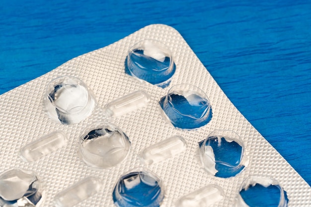 Empty blister pack of tablets on a blue background