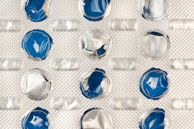 Empty blister pack of tablets on a blue background