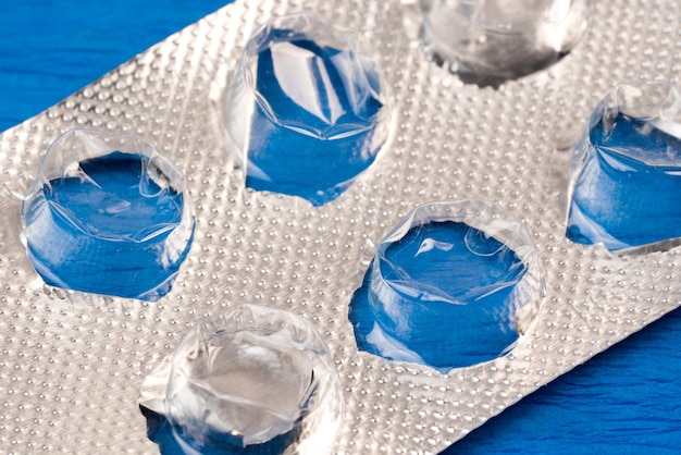 Empty blister pack of tablets on a blue background