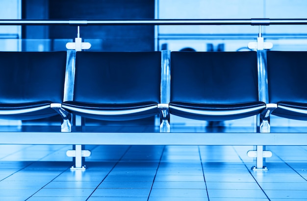 Photo empty blue airport seats bench bokeh background hd