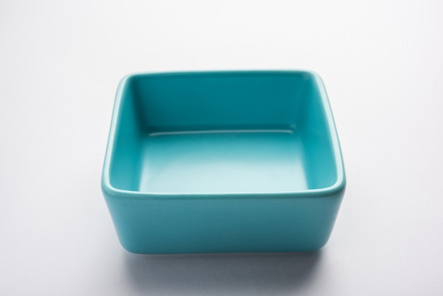 Empty blue ceramic serving bowl, isolated over white surface