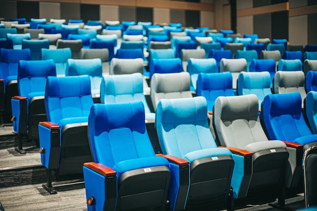 Empty blue cinema seats, chairs. Perspective view