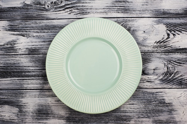 Empty blue plates over wooden table